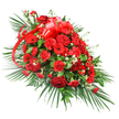 Displayed against a bright white background, this elongated funeral spray in deep reds and greens appears rich, full, and carefully balanced, as if ready to be placed with reverence beside a casket or at the head of a memorial. The centre of the arrangement is dominated by velvety red roses, each bloom detailed with layered petals that curl and fold softly, creating a sense of warmth and intimacy. Interspersed among them, red carnations contribute a dense, cushiony texture with their finely frilled petals, while red gerbera daisies introduce bolder, flatter faces that open wide toward the viewer, their dark centres adding depth and drama. Between the red blooms, small tufts of delicate white flowers-likely baby's breath or miniature chrysanthemums-are threaded like gentle highlights, breaking up the rich tones and giving an airy, almost shimmering quality to the design. The spray is set into a generous base of foliage: long, glossy palm fronds sweep outward in arcs that frame the flowers, while shorter, darker green leaves fill the interior and edges, giving the whole piece a lush, grounded presence. Near the upper middle, a wide red satin ribbon has been tied into an elegant bow, its loops rounded and lustrous, with narrow tails that trail through the arrangement, echoing the dominant red theme. The overall impression is of a dignified, traditional tribute, well-suited for funeral services and cremations in Canonbury and nearby areas, where families seek a strong yet graceful expression of love, respect, and final farewell.