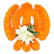A reverent, sculpted floral rendition of the Khanda sits centered against a pristine white backdrop, its silhouette defined with patient craftsmanship and a warm, celebratory palette. Hundreds of small, densely packed bright orange marigold heads have been coaxed into the emblem's distinct parts-the circular chakkar, the two crossed kirpans and the upright double-edged khanda-so that the symbol reads clearly from a short distance yet rewards close inspection with a velvety, tactile surface. At the intersection of the swords, a graceful cluster of at least two fully open white lilies anchors the design; their soft, slightly recurved petals and pale green-and-yellow stamens introduce a cool calm into the composition and offer a subtle, floral perfume that rises from the centre. Surrounding the lilies, glossy green leaves and delicate sprays of tiny white filler flowers, like gypsophila, add depth and breathe between the intense orange masses, while a faint drop shadow on the white ground gives the piece a gentle three-dimensional presence as if hovering above a tabletop. The lighting is soft and even, catching the marigolds' textured surfaces and making the orange glow feel almost incandescent, while the lilies reflect light with a creamy sheen. As a local florist's piece intended for occasions of devotion, remembrance, or festival, this arrangement speaks of dignity and community care: it is the kind of floral emblem you might see laid in a Gurdwara or offered at a Vaisakhi or Gurpurab observance. For residents around Canonbury and neighbouring Islington streets-Upper Street, Essex Road and Canonbury Square-this image conveys both the craft of floral art and the quiet reverence of shared ritual.