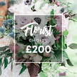From a Canonbury-based florist, this Florist CHOICE bouquet sits in a close-up that invites a quiet, intimate gaze. A soft white rectangular overlay sits at the center, bearing Florist CHOICE and the price ?200 in luminous white type, as if inviting a moment of decision. The bouquet glows in a restrained pastel palette: fully opened light pink garden roses, creamy white and pale lavender-grey roses, and crisp white anemones with their signature almost-black centers. A touch of subtle purple-grey adds depth, while blue eryngium thistles provide a crisp, architectural sparkle and a cool note amid the sweetness. Lush greenery threads through-the slender eucalyptus-like leaves and deeper burgundy or plum-toned leaves weaving through the stems, giving the arrangement movement and a natural, substantial feel. The composition feels artfully curated, with a sense of gathered abundance that suggests it could have been picked fresh from a sunlit corner garden near Upper Street or Newington Green. The background is softly blurred, as if outdoors or in a bright conservatory, so every petal seam and leaf vein is made visible. This image embodies a bespoke floral service-high-quality blooms chosen with seasonal care, suitable for a wedding, an anniversary, or a meaningful gift at the ?200 price point. In Canonbury and the surrounding Islington neighbourhoods, from Dalston to Essex Road, the bouquet carries the confidence of local craft, ready for delivery to your door.