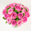 A sumptuous, lush bouquet of roughly two dozen pink roses sits poised in a simple clear glass vase, photographed against a clean, uniformly lit white backdrop. The composition is densely packed and rounded, each rose fully or nearly fully open so that layers of velvety petals ripple outward from tight, deeper-coloured centres. The palette moves from a rich fuchsia or magenta in the heart of some blooms to softer rosy pinks and delicate blush tones at the petal edges, creating a natural ombré that gives the arrangement depth and a sense of movement. Small sprays of dark, glossy green leaves are tucked between the blooms, their cool tones sharpening the warmth of the pinks and lending a freshly cut, garden-picked feel. The image is taken from a slightly elevated, overhead angle, which emphasises the bouquet's generous fullness and its harmonious rounded silhouette, inviting the viewer to imagine its weight in the hands and the soft friction of petals against fingertips.

Under soft, diffuse daylight the surface textures-the satiny sheen of petals, the matte veining of leaves, the faint reflection on the vase-are gently revealed, while a subtle rosy scent seems almost present in the picture. This arrangement carries a mood of celebration and tender affection: it reads as a romantic gesture, a Mother's Day surprise, or an elegant centrepiece for an intimate anniversary dinner. For someone in Canonbury or nearby on Essex Road or Angel, the bouquet suggests local craftsmanship and thoughtful selection of blooms, perfect for marking a joyful moment with colour, scent and classic floral beauty.