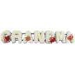A refined floral name tribute carefully spells out GRANDMA in six bold capital letters, each one shaped from a dense covering of pure white cushion chrysanthemums that create a soft, almost quilted texture. The letters stand side by side in a straight line, supported on a low, dark green base that is mostly hidden behind the blooms, ensuring the focus remains on the flowers and the clearly written word. Around the edges of each letter, a delicate edging of pale lavender or soft purple ribbon peeks through, framing the white petals with a gentle hint of colour and giving the design a composed, finished look. The tribute is further enriched with carefully placed clusters of vivid red flowers, symbolising deep affection and remembrance: the G features a small grouping of velvety red roses and a distinctive red-and-white variegated calla-style bloom; the first A is adorned with a single, heart-shaped red anthurium near its base; the central M displays a mix of red roses and another anthurium; and the final A is marked by one more red anthurium, creating a graceful visual echo from start to finish. Photographed against a plain white background, every detail of the craftsmanship is easy to imagine, from the cool, smooth stems beneath the flowers to the gentle fragrance that might fill a quiet chapel in Canonbury or close to Highbury Corner. This piece feels like a tender, personalised farewell, the kind of floral lettering a family would choose to honour a cherished grandmother's memory with clarity, warmth, and understated elegance.