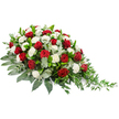 A classic red and white memorial spray is photographed against a simple white background, drawing attention to its graceful shape and solemn beauty. Designed to lie flat, the arrangement runs horizontally with a fuller cluster of flowers on the left that gently tapers to a fine, trailing point on the right, like a soft sigh of blossoms. Deep red roses, their velvety petals still beautifully furled, are distributed throughout the spray, each one a focal point of emotion, symbolising love that endures beyond parting. Interwoven with them, white carnations open into soft, frilled blooms, their texture reminiscent of delicate lace and their brightness offering a sense of serenity and hope. The flowers are nestled into a foundation of luxuriant greenery: glossy dark leaves form a dense, supportive base, while muted, silvery eucalyptus leaves are threaded between the blooms, lending depth and a gentle, misty tone. Towards the right-hand tip, slender, trailing sprays of lighter green foliage extend gracefully outward, adding a natural, flowing feel as though the arrangement is gently reaching out in farewell. The overall impression is calm, respectful, and thoughtfully balanced, ideal as a casket spray or sympathy tribute for a funeral in Canonbury or around nearby Islington streets. One can imagine this piece delivered fresh on the morning of a service, travelling quietly along Canonbury Road before being placed with care beside a loved one. Its harmonious blend of red, white, and green offers a tender, visual expression of condolences, honouring memories with dignity and warmth.