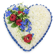 A top-down view reveals a meticulously crafted, heart-shaped funeral tribute, its outline crisp and symmetrical against a plain, light background. The main body of the heart is composed entirely of small white chrysanthemum heads, packed tightly so that no gaps show, producing a soft, cushion-like surface that conveys serenity and purity. Enveloping this white expanse is a royal blue satin ribbon, pleated all around the perimeter. The ribbon's ruffled edge adds both volume and refinement, and the glossy fabric catches the light in gentle highlights, giving the heart a subtle sense of depth. On the top left side, a striking focal arrangement draws the eye. Here, several deep red roses, open and velvety, nestle in a base of dark green foliage, the leaves providing contrast and structure. From the roses, slender stems of electric blue dendrobium orchids extend and fall diagonally into the heart's centre, their starry flowers adding vibrant colour and a flowing, almost cascading movement. Fine tendrils of light green foliage curl among them, lightening the composition and adding a whisper of wildness. On the lower right curve sits a single red rose, carefully placed with a touch of greenery so it appears as a solitary echo of the main spray, suggesting one special person held in remembrance. The overall mood is one of gentle solemnity and enduring affection, perfectly suited to a memorial or funeral service in Canonbury, perhaps delivered by a local florist for a ceremony in a nearby church or crematorium, where it would rest close to the coffin as a final expression of love.
