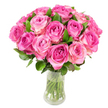 A lush, domed bouquet of roughly two dozen fresh pink roses sits in a clear glass vase against a crisp white background, every element rendered with the careful eye of a neighbourhood florist. Each bloom opens in concentric spirals, the petals graduating from a concentrated fuchsia or magenta at the tightly furled heart to softer blush and sometimes creamy-white tones along the outer edges. The roses are packed closely together to form a full, rounded silhouette; dark green, glossy leaves peek between heads and cup the flowers, adding a cool visual counterpoint and a hint of texture. Through the transparent vase, the neatly cut green stems are visible, submerged in clear water; the glass curves gently, narrowing at the middle before flaring slightly at the rim and base, catching highlights from the even studio lighting. That bright, neutral light sculpts each petal's satiny surface, making the subtle folds and edges readable to the eye and suggesting how soft they would feel to the touch. Imagine the faint, fresh sweetness of garden-scented roses rising above the arrangement - a gentle, almost fruity perfume that evokes early summer mornings on Canonbury's quieter streets. This composition reads as both modern and timeless; it's suited to anniversaries, Mother's Day, birthdays, or simply as a warm gesture of affection. As a florist who often prepares seasonal arrangements for homes around Canonbury Square and nearby Upper Street, I note how the colour gradient and tight, crafted shape allow these roses to function equally well as an elegant centrepiece or an intimate gift delivered across the local area.