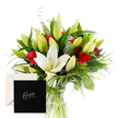 A striking bouquet unfolds with elegant simplicity, pairing the refined purity of white lilies with the passionate red of classic roses. Each lily, some delicately opening while others remain in poised bud, releases a gentle, sweet scent-like a soft spring morning in Canonbury. The roses, velvety and rich, nestle among lush, vivid green foliage, their fiery presence radiating admiration and strength. Hints of eucalyptus and wispy grasses add movement and a subtle herbal freshness, while light cascades across the petals, illuminating the crisp contrast and the decadent texture of each bloom. This arrangement speaks of gratitude and reverence, an ode to someone cherished and extraordinary-a vibrant tribute for a milestone, a heartfelt thank you, or simply to celebrate a personal hero. The bouquet appears in a clear glass vase, arranged by Canonbury Flowers to catch the glow from a nearby window on Upper Street or New North Road. Available for same-day delivery across Canonbury, Islington, and adjacent neighbourhoods, it makes a thoughtful gift for a friend in Highbury Fields or Dalston too. The design fuses bold colour and serene balance, with the leaves offering a cooling backdrop to the luminous whites and passionate reds, a tactile symphony that invites touch and memory. It is a living reminder of the community's warmth, crafted with care by a local studio that understands the language of gratitude and celebration in Canonbury.